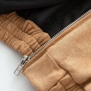 Detailed macro view of high-quality faux suede fabric texture and durable metal zipper