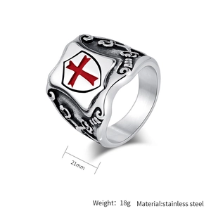 Detail view of vintage stainless steel shield ring with red enamel cross at 45 degree angle