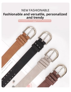 Detail of four suede leather belts with metal studs and silver D-shaped alloy buckles