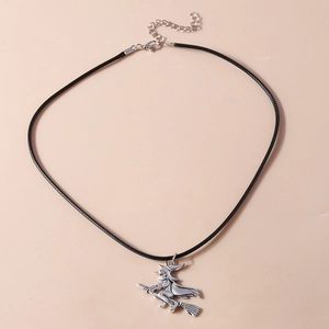 Detail of silver witch on broomstick pendant with black cord and lobster clasp