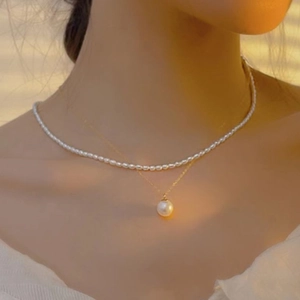 Detailed view of layered 14K gold-plated necklace with elegant mini freshwater pearls