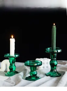 Three-piece set of green ribbed glass candle holders in various heights for home decor