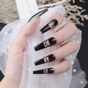 Long coffin press-on nails in glossy black with pink baby and artistic line art patterns