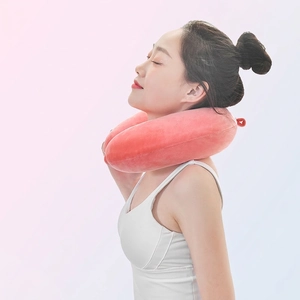 Pink memory foam U-shaped travel neck pillow shown on a female model with ergonomic support