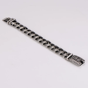 Detailed view of the vintage silver Cuban chain featuring intricate tribal engravings