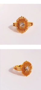 Close-up of a gold-plated vintage ring featuring a clear zircon and radial metal beads