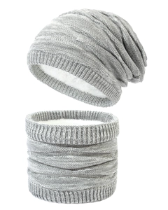 Detail of grey knitted hat and neck warmer with thick white fleece lining for winter