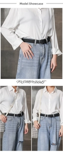 Model wearing a black braided waist belt with vintage metal buckle over denim pants