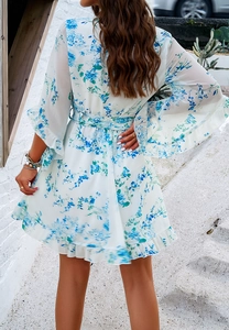 Back view of floral chiffon dress with bell sleeves and waist tie on outdoor steps