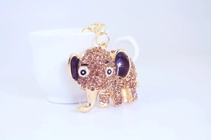 Close-up of golden elephant keychain with sparkling rhinestones and enamel details