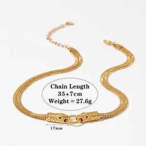 Golden stainless steel snake head necklace with flat bone chain and green stone eyes