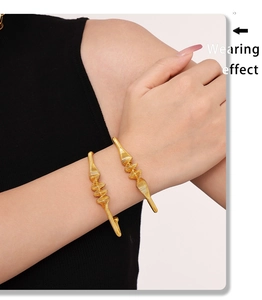 Wearing effect of golden twisted spiral bangle with unique wave texture on wrist