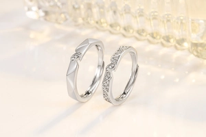 Macro detail of couple rings with geometric facets and pave-set zircon crystals