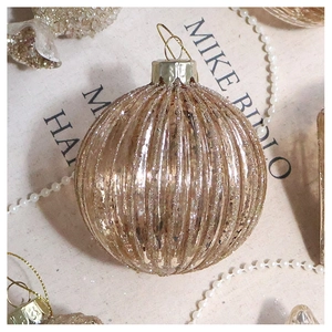 Detailed view of champagne gold ribbed glass Christmas ornaments with glitter finish