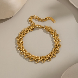 Detail of a gold double-row link bracelet with lobster clasp and extension chain