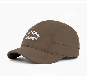 Detailed close-up of mountain peak embroidery on coffee quick-dry baseball cap fabric