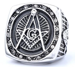 Macro shot of Freemason ring with G letter, black enamel, and paved stones on sides