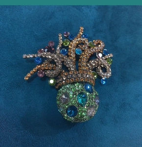 Detailed close-up of a vintage gold octopus brooch encrusted with multi-colored crystals