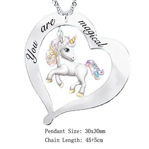 Detailed view of silver heart pendant with unicorn and 'You are magical' engraving