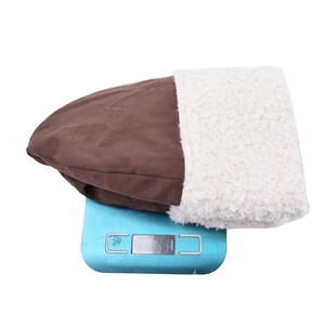 Winter solid color fleece bucket hat in brown and white showing 91g weight on a scale