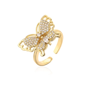 Detail of gold butterfly open ring featuring sparkling cubic zirconia on white background