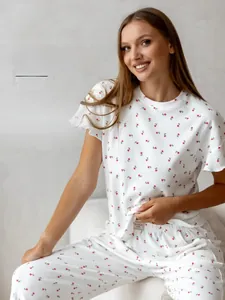 Detail of red floral print on waffle knit fabric of white loungewear set for women