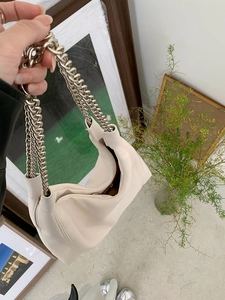 Detail of cream white pleated soft leather tote with thick silver chain strap