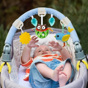 Infant stroller activity arch with plush bird and owl toys being used by a baby in a pram