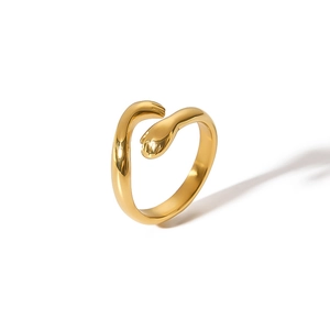 Macro shot of gold-plated stainless steel hugging hands ring with an adjustable open band