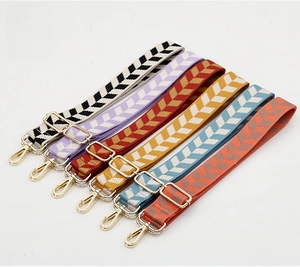 Detailed display of vintage jacquard replacement bag straps with gold metal hardware
