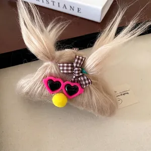 Cute monster hair claw clip with plush braids and heart sunglasses on a cozy background