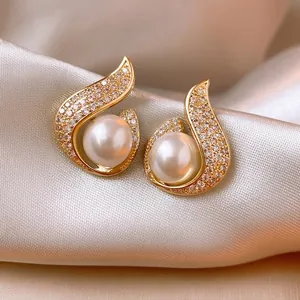 Elegant gold mermaid tail stud earrings with luminous pearls and sparkling crystals