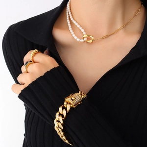 18k gold plated stainless steel necklace with freshwater pearls on a black ribbed outfit