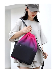 Detail of waterproof nylon drawstring backpack featuring a pink and black gradient finish