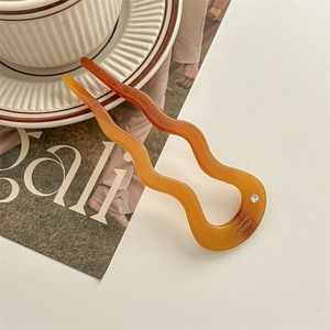 U-shaped tortoise acetate hair pin with wave design and crystal detail on magazine