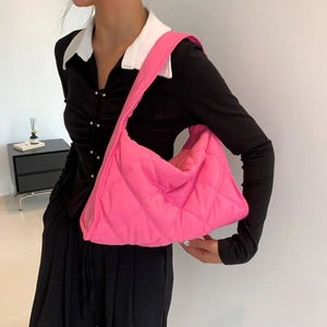 Close-up of pink quilted nylon padded shoulder bag with soft diamond lattice pattern