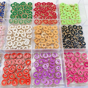 Colorful hollow heart alloy pendants sorted in a grid storage box for DIY jewelry making