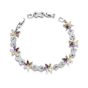 Macro detail of 925 silver bracelet featuring colorful zircon flowers and infinity symbols