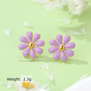 Macro shot of purple daisy earrings with gold centers showing dimensions 1.2cm and 2.3g