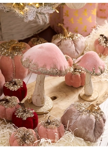 Macro detail of velvet mushroom and pumpkin decor with gold sequins for Christmas