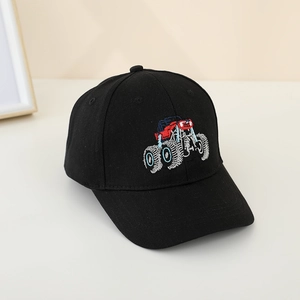Close-up of colorful monster truck embroidery on a black cotton baseball cap for kids