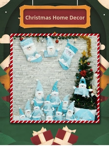 Detailed view of light blue Christmas gonks and plush snowman dolls with festive socks