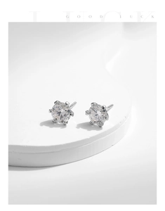 Detail of S925 sterling silver classic six-prong stud earrings with sparkling moissanite