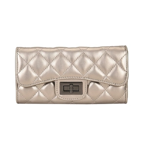 Detail of champagne gold quilted wallet with classic metal turn-lock and metallic finish