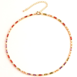 Close-up of golden necklace featuring colorful rectangular gemstones and lobster clasp
