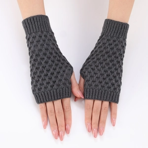 Detail of grey knitted fingerless gloves showing the textured diamond weave pattern