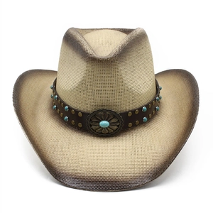 Detail of western straw cowboy hat with leather band and turquoise stone buckle