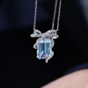 Blue princess cut square gemstone pendant necklace with crystal bow in silver finish