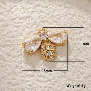 Macro view of gold-plated bee charm with white shell and zircon, size 15mm x 11mm