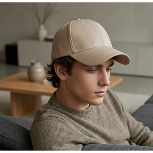 Detail view of beige leather baseball cap with premium texture and stitch on brim